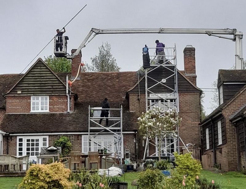 The Roof Moss Cleaners using cherry picker and scaffolding to clean roof safely and professionally in Wootton, Bedfordshire